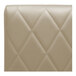 The beige leather single back of an Olympic diamond tufted booth.