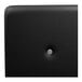 A black leather surface with a round button and white circle in the middle.