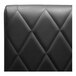 A black leather QA Group restaurant booth back with diamond tufting.
