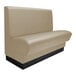 A beige leather booth seat with black legs.