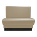 A beige leather QA Group restaurant booth with black legs.