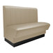 A beige booth seat with a black base.