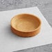 A Pidy sweet butter tart shell on a white paper.