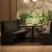 A black QA Group single channel back booth in a restaurant dining area.