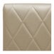 A close-up of the beige leather diamond tufted back of a QA Group booth.