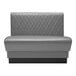 A grey leather booth with a black diamond tufted back.