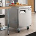 An Avantco stainless steel undercounter freezer with a cutting board on top.