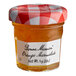 A Bonne Maman mini jar of orange marmalade on a table with a label.