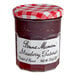 A Bonne Maman strawberry preserves jar with a red and white checkered lid.