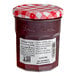 A Bonne Maman jar of strawberry preserves with a red and white checkered lid.