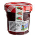 A Bonne Maman mini jar of raspberry preserves with a red and white checkered lid.