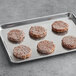 A tray of Hungry Planet plant-based beef burger patties.