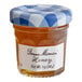 A Bonne Maman mini jar of honey with a blue and white checkered lid.