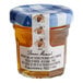 A Bonne Maman mini jar of honey with a blue and white label.