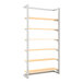 A white metal Econoco wall-mounted retail display with wood shelves.