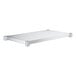 A galvanized steel undershelf for a work table.