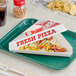 A pizza slice in a Choice white clay-coated box on a tray.