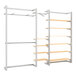 A white and silver metal wall-mount retail display with shelves, a hangrail, and faceouts.