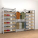 A white wall with an Econoco retail display kit with shelves and a hangrail holding clothes.
