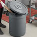 A grey Advantage Supplies 20 gallon round trash can with a lid.