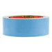 A close-up of a roll of blue Gorilla double-sided tape with orange writing on it.