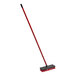 A red Libman floor scrub with a black and red handle.