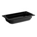 A Vollrath black polycarbonate food pan on a counter.