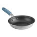 A close-up of a Vigor 8" aluminum frying pan with a blue silicone grip.