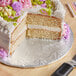 A close-up of a cake on a silver round cake drum.
