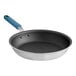A close-up of a Vigor A3000 Series fry pan with a blue silicone handle.