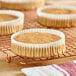 A close-up of a white fluted jumbo cupcake wrapper with a cupcake inside.