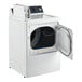 A white GE front load commercial dryer with the door open.