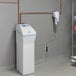 A white rectangular GE Smart Whole House Water Filtration System with a blue screen next to copper pipes.