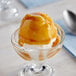 A bowl of yellow ice cream topped with Kraft caramel sauce.