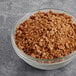 A bowl of Yum Crumbs Pumpkin Pie crumb topping on a table.