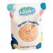 A close-up of a Yum Crumbs bag of Orange Creamsicle crumb topping.