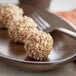 A plate of Yum Crumbs apple pie crumb balls with a fork.