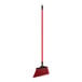 A red O-Cedar Commercial broom with a long black handle.