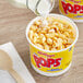A container of Kellogg's Corn Pops cereal with milk pouring into it.