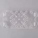 A clear plastic Vollrath drain tray with holes.