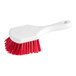 An O-Cedar red and white utility brush with a white handle.