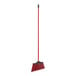 A red broom with a black steel handle.