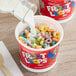 A bowl of Kellogg's Froot Loops cereal with milk being poured into it.