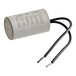 A close-up of a white Cooking Performance Group conveyor motor capacitor with black wires.