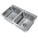 A stainless steel Advance Tabco double bowl drop-in sink.