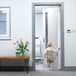 A baby walking through a white door with a white L.A. Baby Fingershield on it.