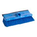 A close-up of a blue Lavex deck brush with black bristles.