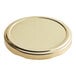 A close up of an 82mm gold metal lid.