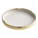 A close up of a gold metal lid with a white plastisol liner.