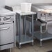 A Regency galvanized steel undershelf on a table in a kitchen.